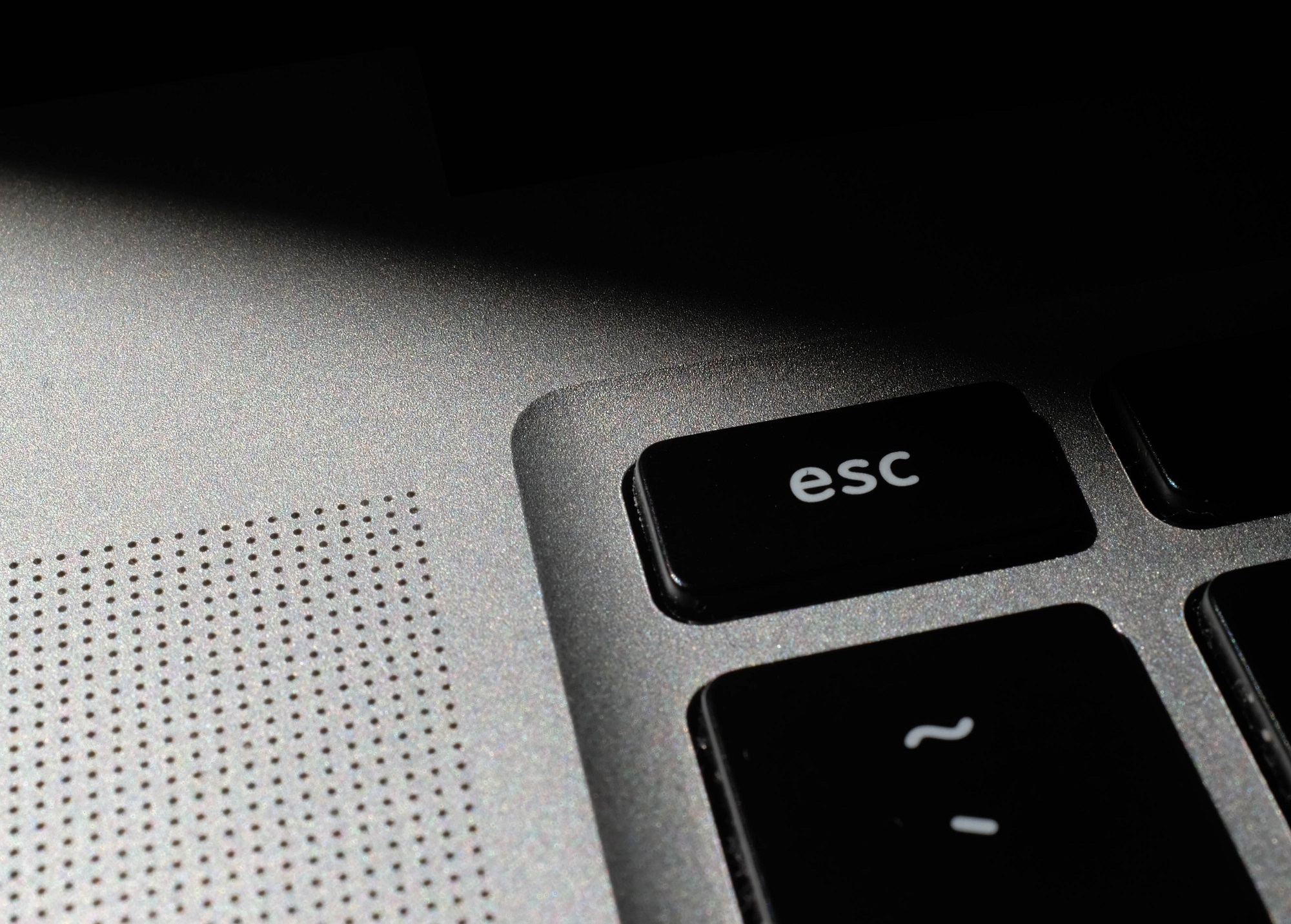 closeup of "esc" button on the corner of a keyboard