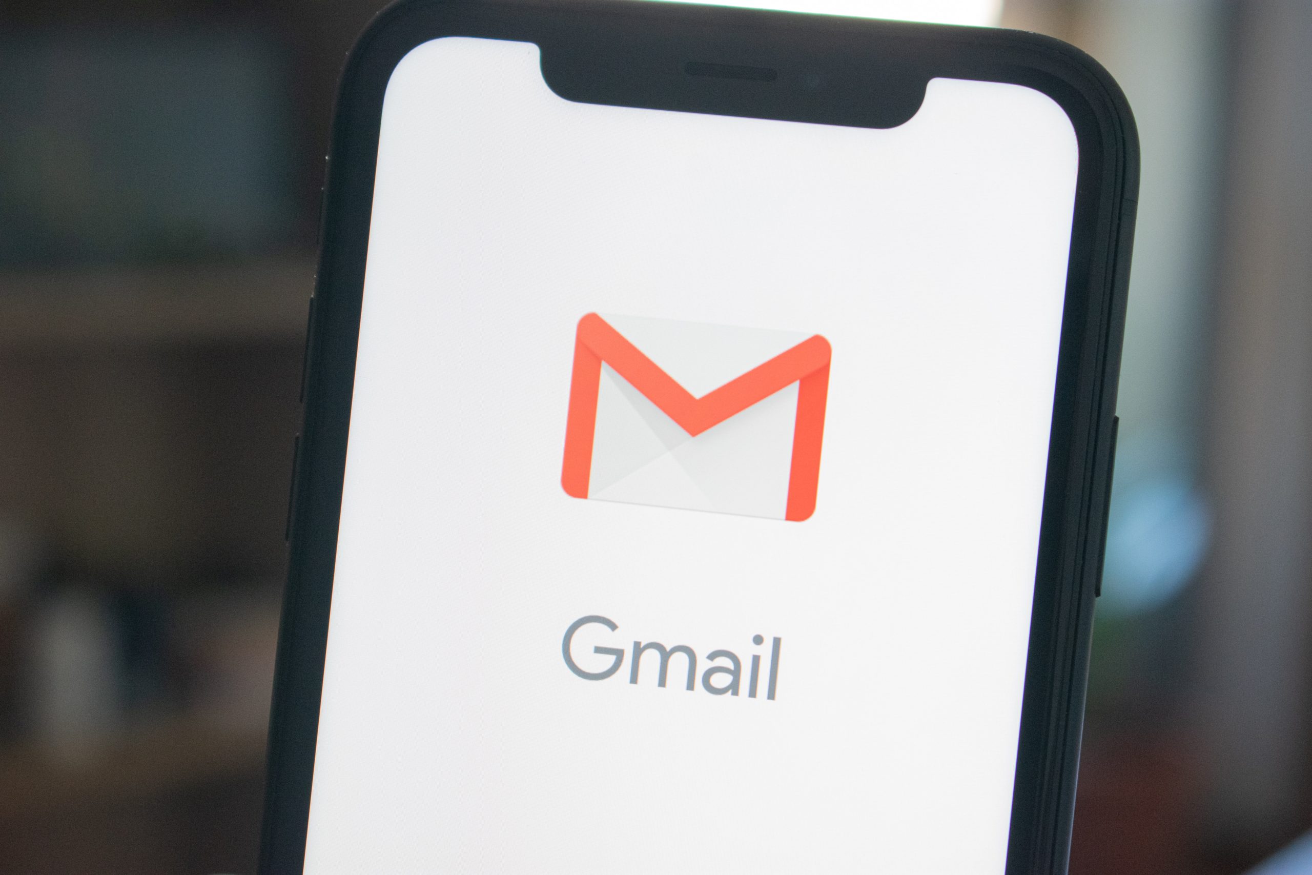 making email mobile friendly depicted in a picture with the Gmail icon on the screen of a smart phone