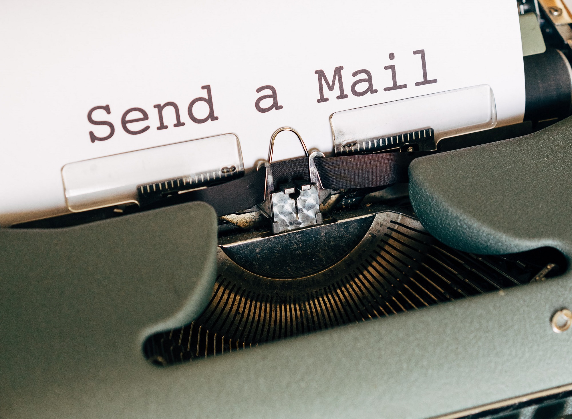 message on a paper still in the typewriter feed reads "send a mail" signifies to be straight to the point