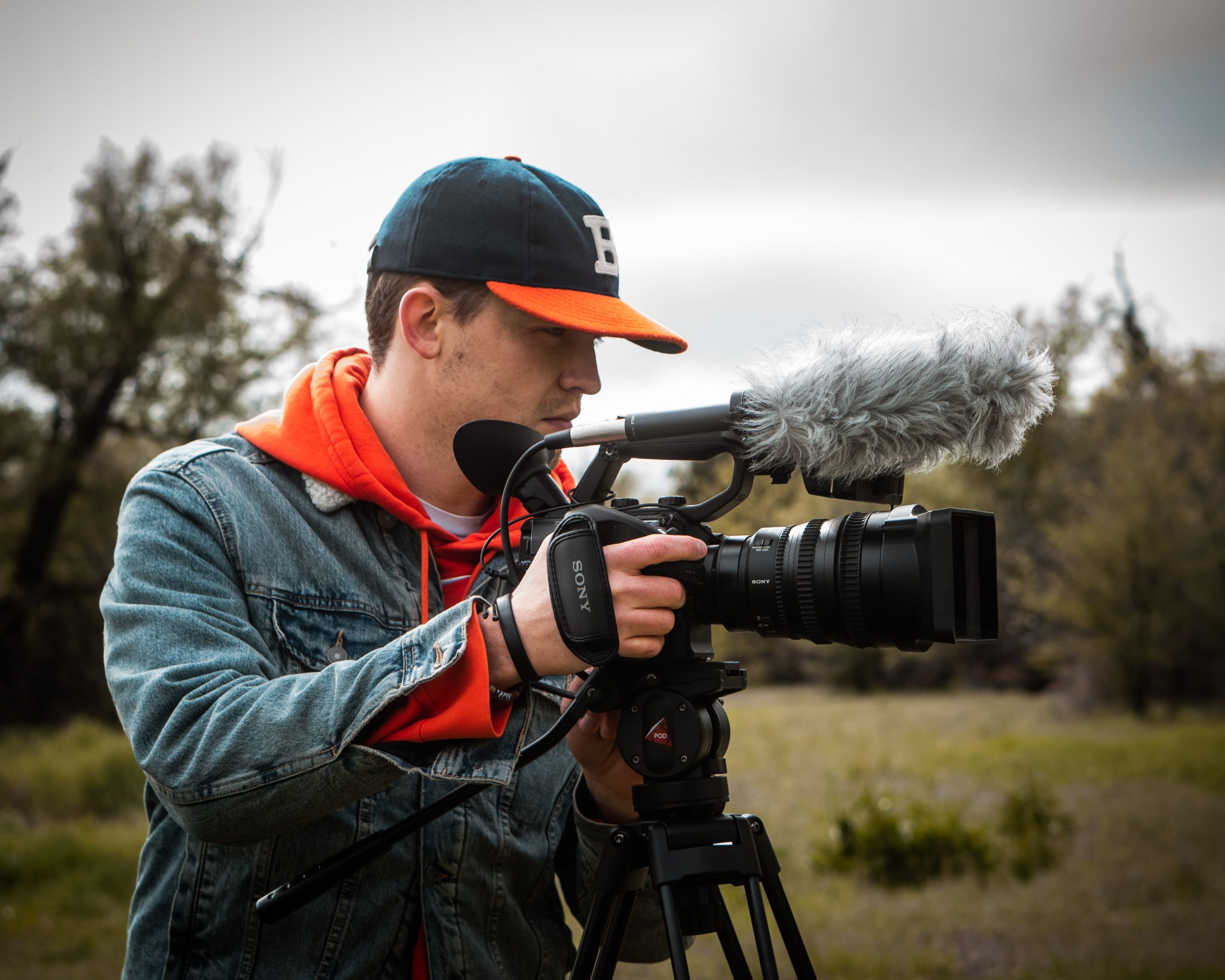 A freelance videographer making a video using his video camera