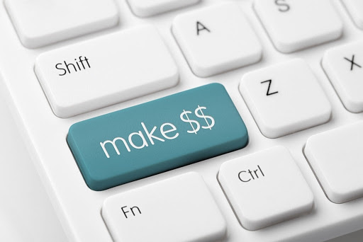 close up of a computer keyboard where a differently colored button reads, "Make $$"