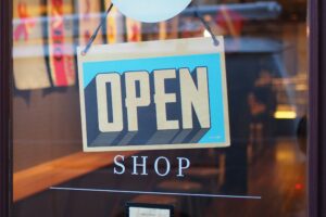 open sign on glass door with the word shop