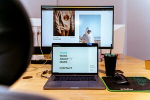 laptop and monitor showing images of an e-commerce business website
