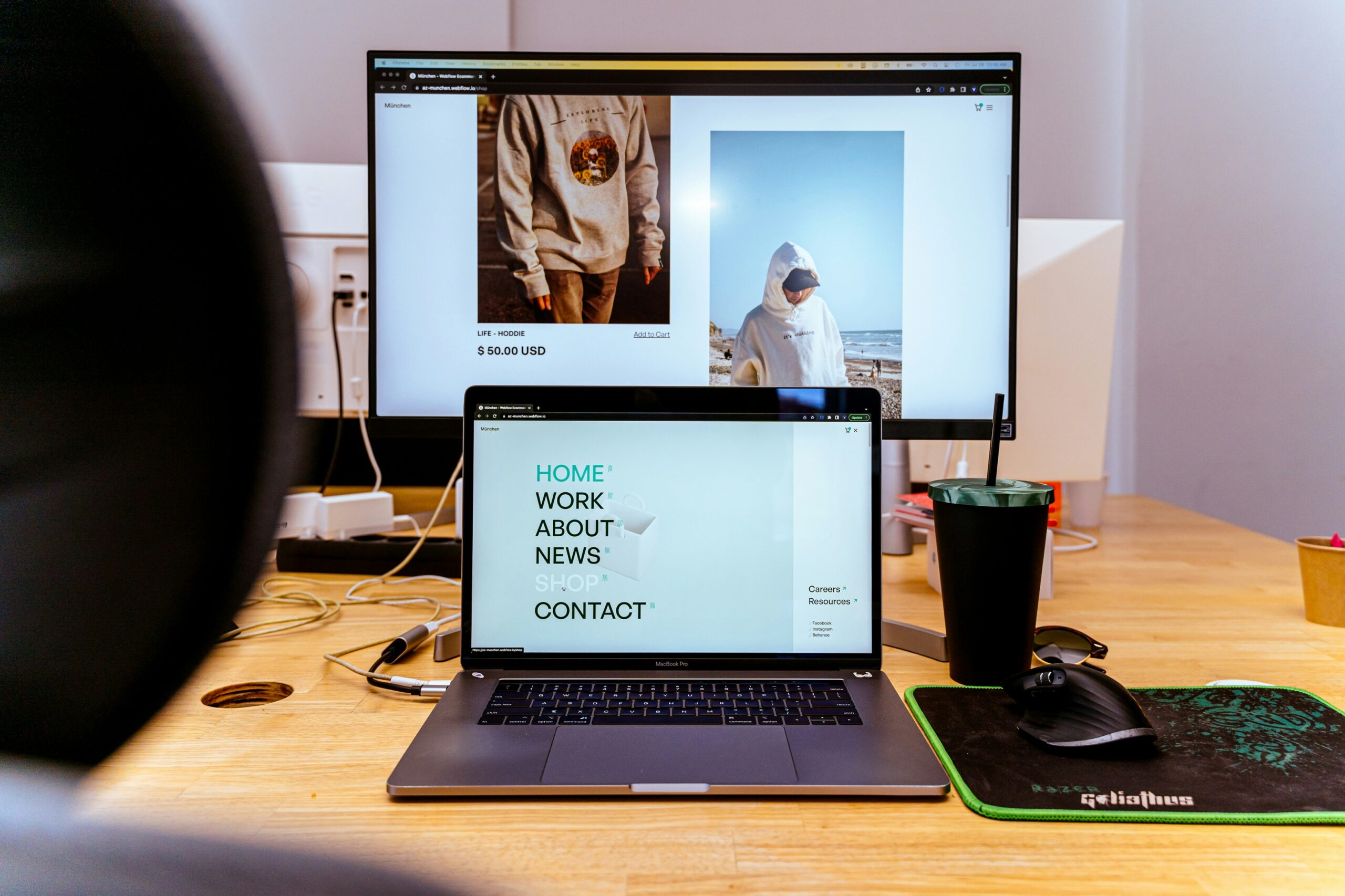 laptop and monitor showing images of an e-commerce business website