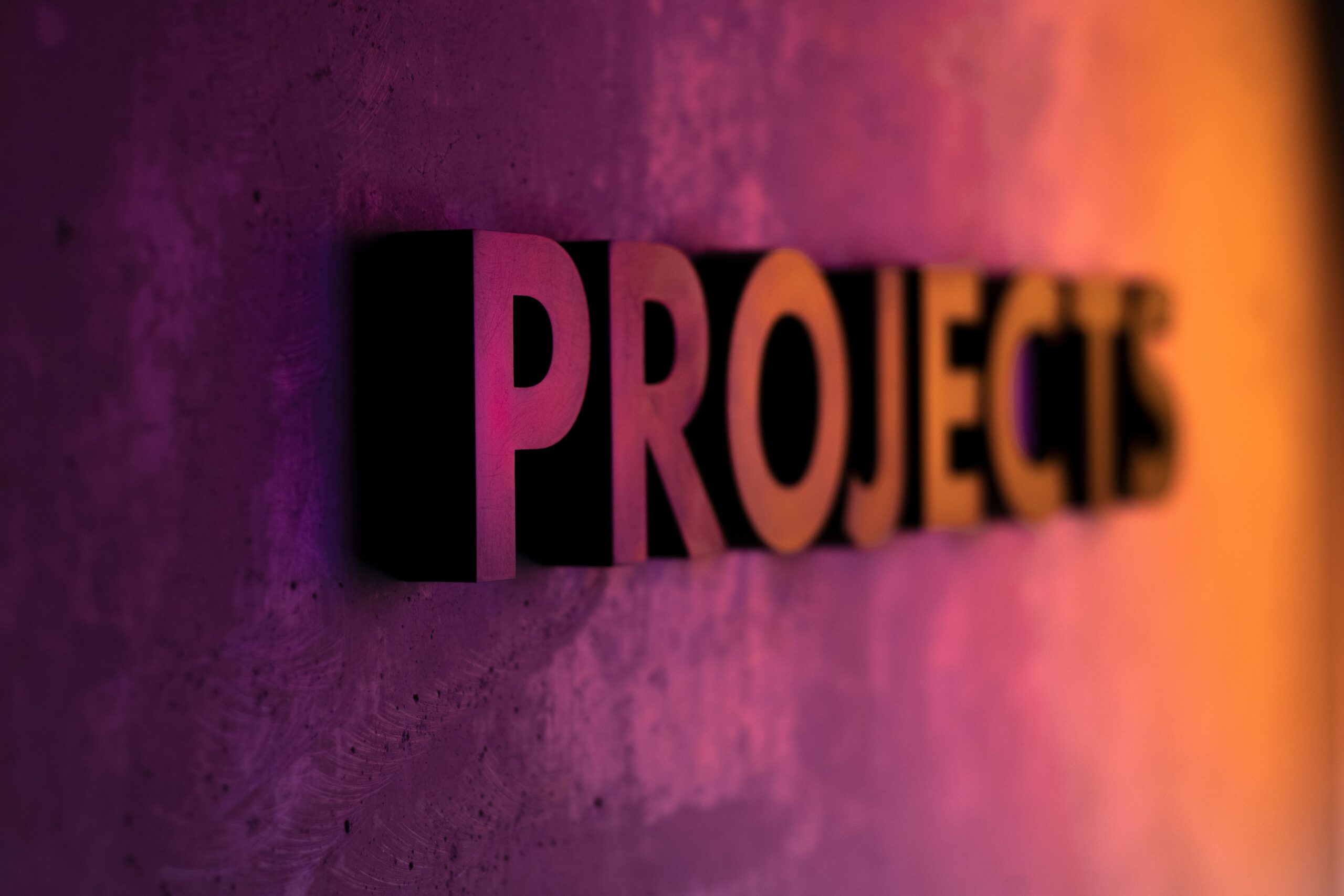 The word projects at an angle with purple and light orange lighting